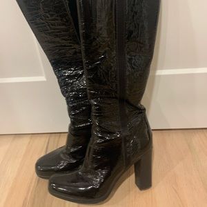 Leather PRADA boots with side zipper. The logo decorates the leather.